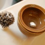 hot water in the bottom bowl, a small dollop of shaving cream in the top bowl...